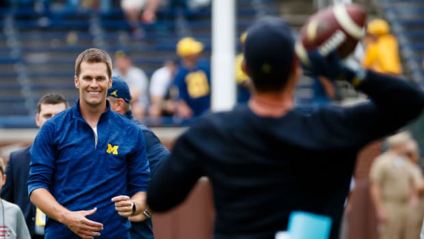 Sep 17, 2016; Ann Arbor, MI, USA; New England Patriots quarterback Tom Brady and Michigan Wolverines head coach Jim Harbaugh pass the ball around during warm ups prior to the game against the Colorado Buffaloes at Michigan Stadium. Mandatory Credit: Rick Osentoski-USA TODAY Sports